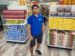 man in supermarket wearing a blue polo s
