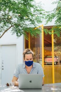 man working from home wearing a mask